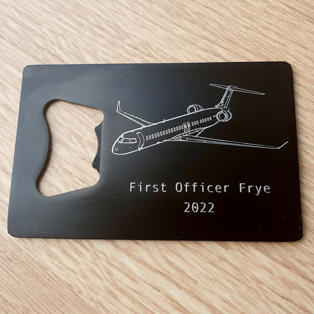 Bombardier CRJ 900 aircraft engraved on black bottle opener with personalised name.