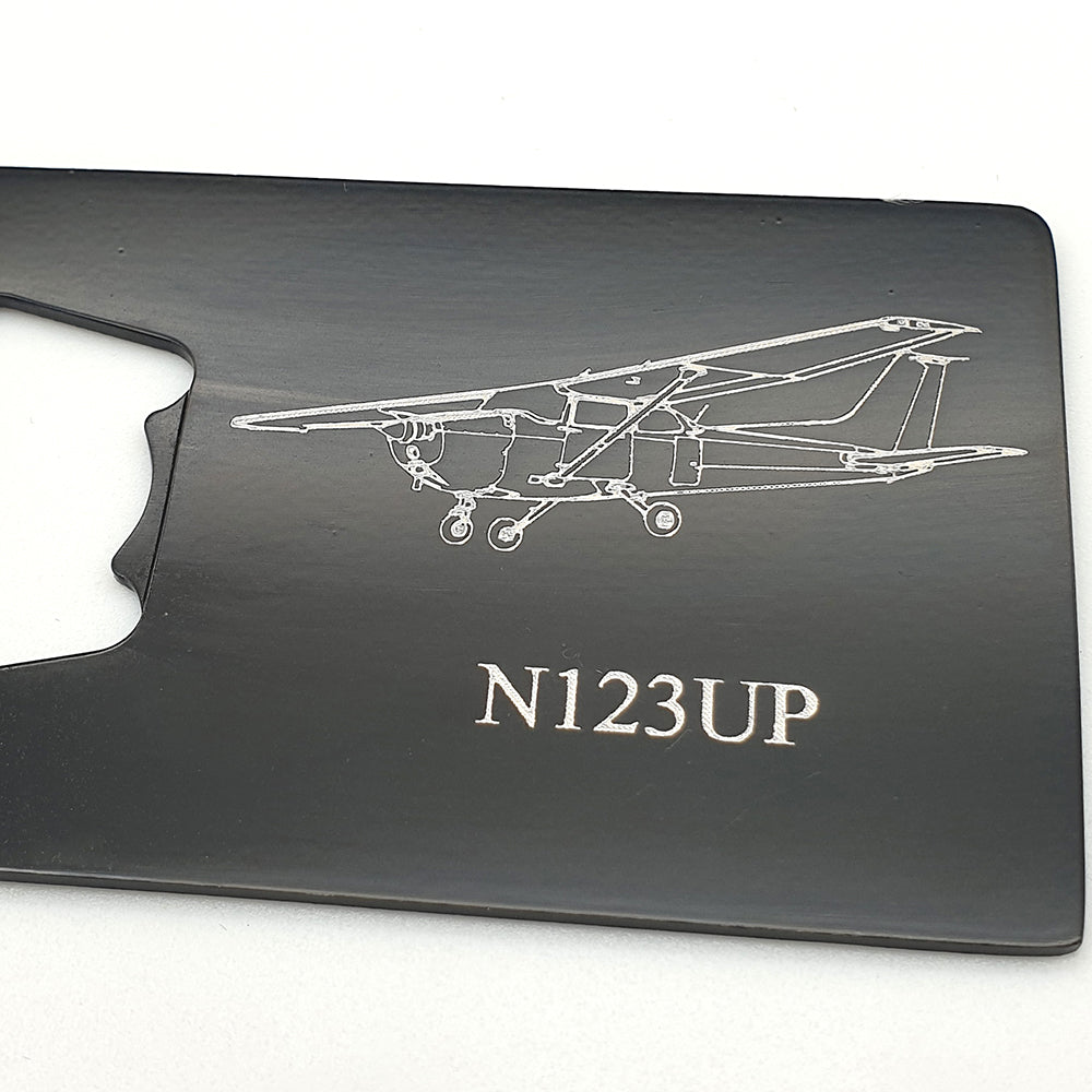 Black bottle opener with Cessna 172 artwork on white background