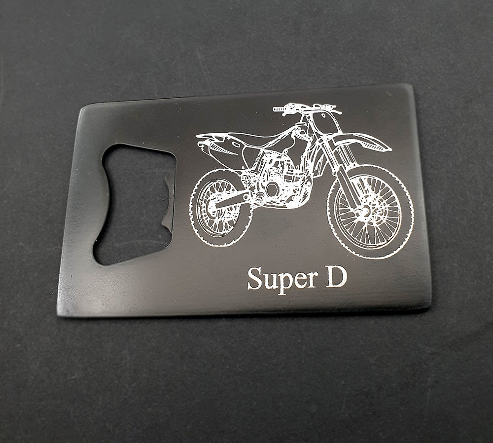 Black bottle opener with white dirt bike design and 'Super D' text on a black background