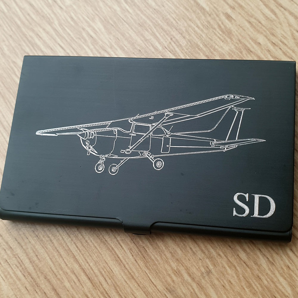 Cessna 172 with no fairings engraved on the front of a card holder with initials engraved in the corner