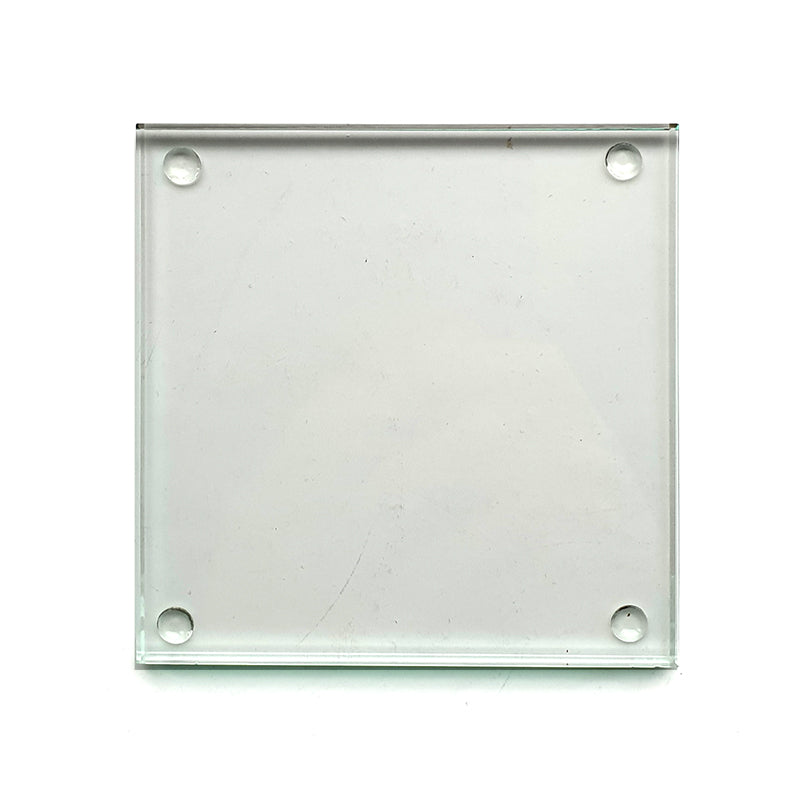 square glass drinks coaster with rubber backing studs shown on a white background