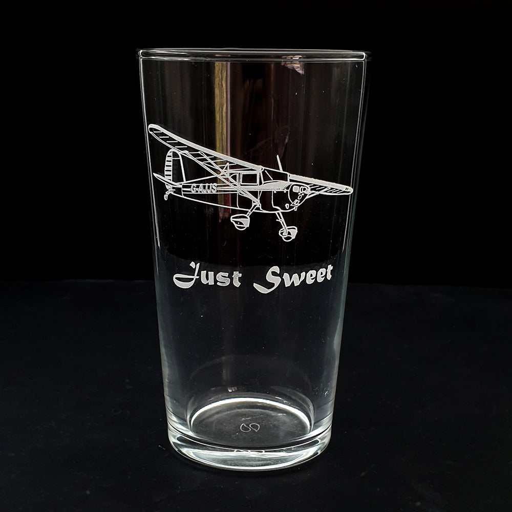 Clear beer glass with personalised Cessna 120 airplane design and 'Just Sweet' text on a black background