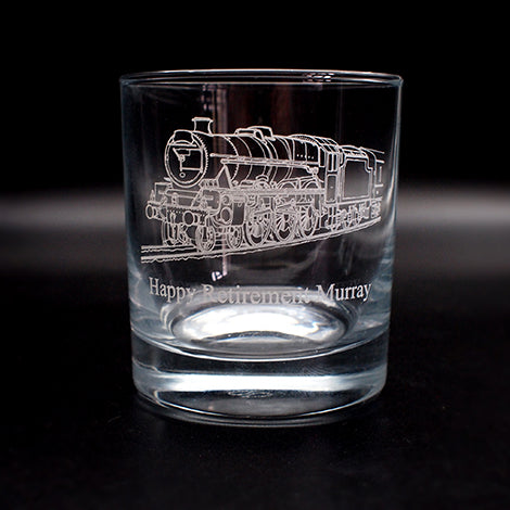 Glass tumbler with engraved steam train design and 'Happy Retirement Murray' text on a black background