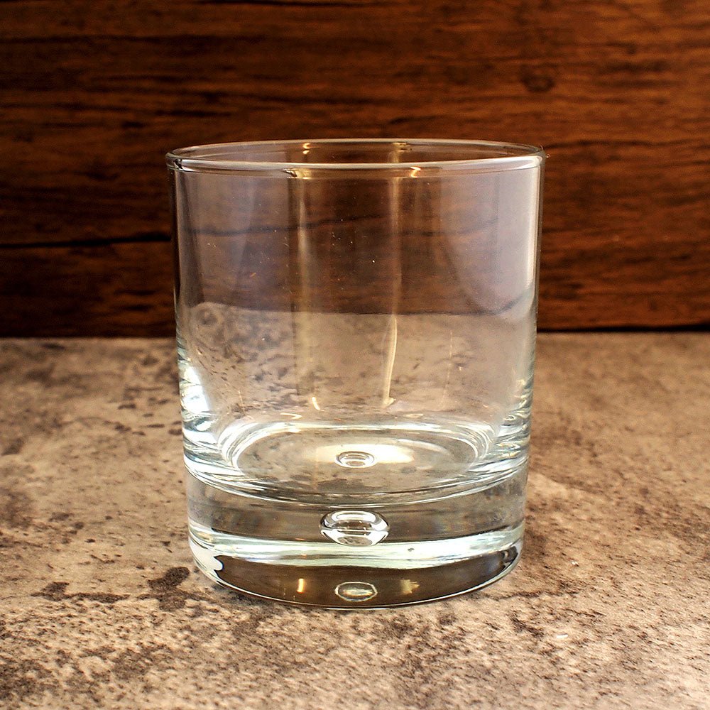 close up of glass tumbler with floating bubble base detail