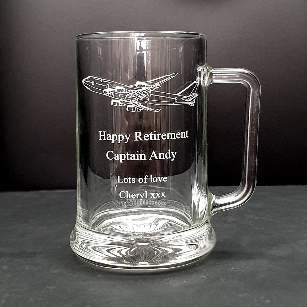 Clear glass mug with 747 airplane engraving and personalized text on a dark background