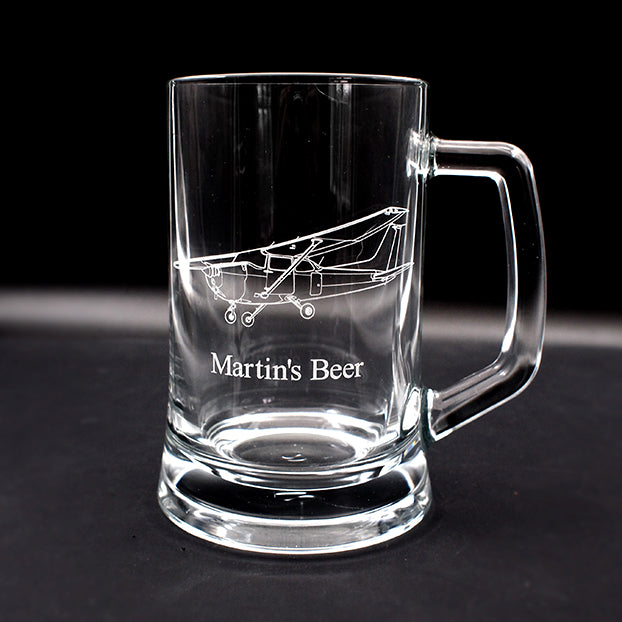 Clear glass mug with Cessna 172 design engraved design and 'Martin's Beer' text on a black background