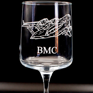 wine glass with C17 globemaster airplane engraving and 'BMC' text on a black background