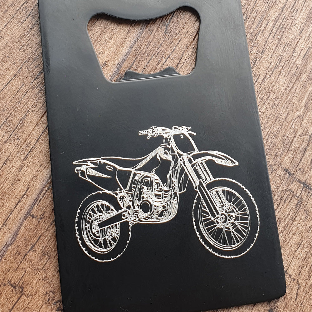 Dirt bike motocross design engraved on black bottle opener in Portrait orientation.