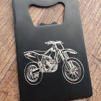Dirt bike motocross design engraved on black bottle opener in Portrait orientation.