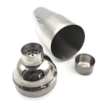 Stainless steel cocktail shaker with components on a white background