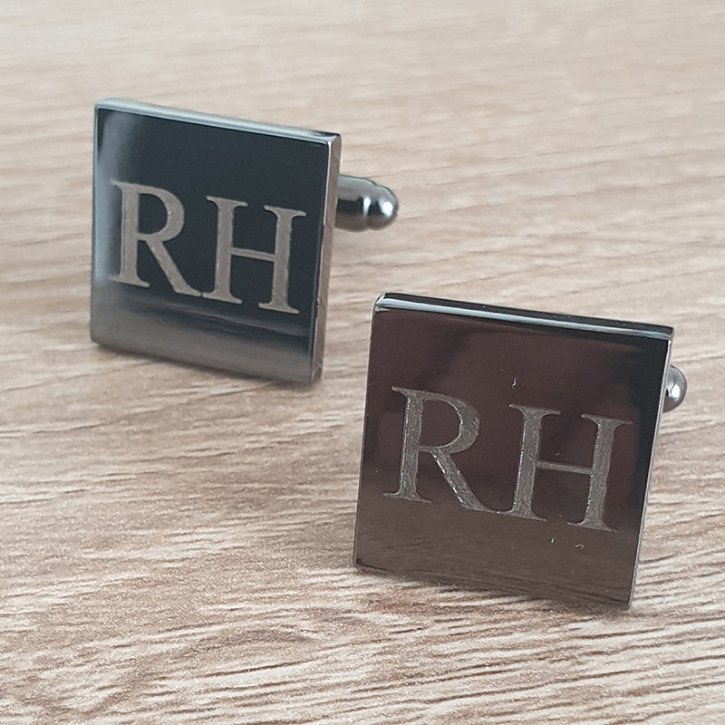 Silver Square cufflinks with 'RH' initials on a wooden surface background
