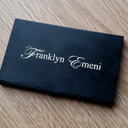 Black card holder with name engraved in Edwardian script font on the front