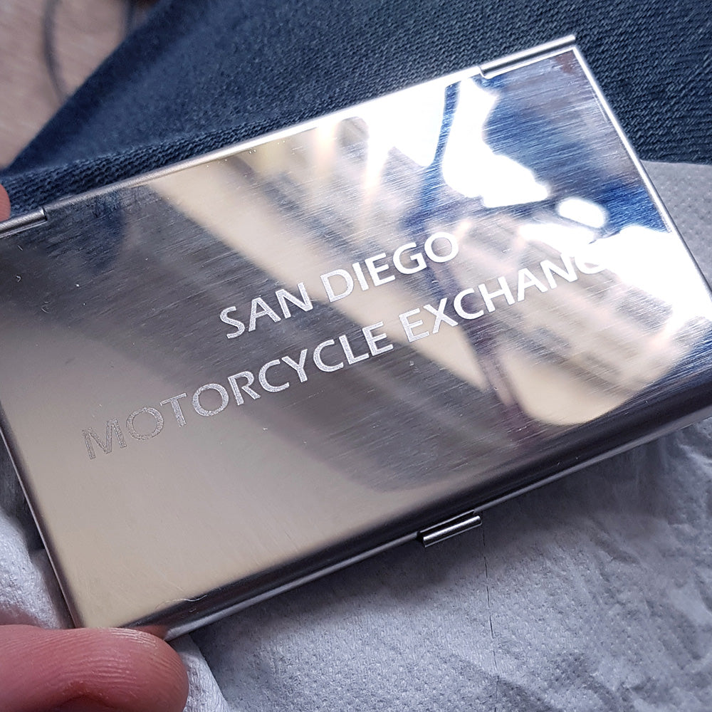 Back of steel card holder engraved with san diego motorcycle exchange text