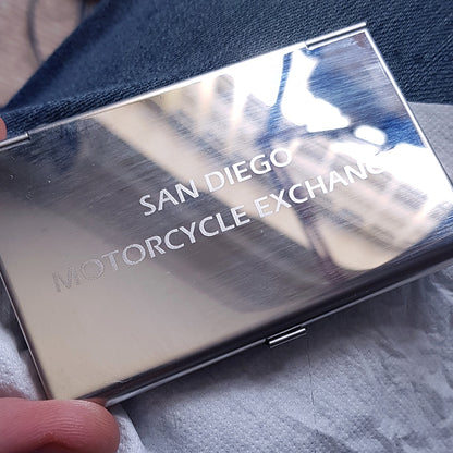 Back of steel card holder engraved with san diego motorcycle exchange text