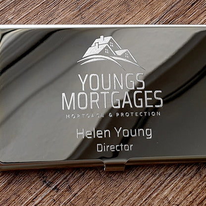 Metallic business card with 'Youngs Mortgages' logo and text on a wooden surface background