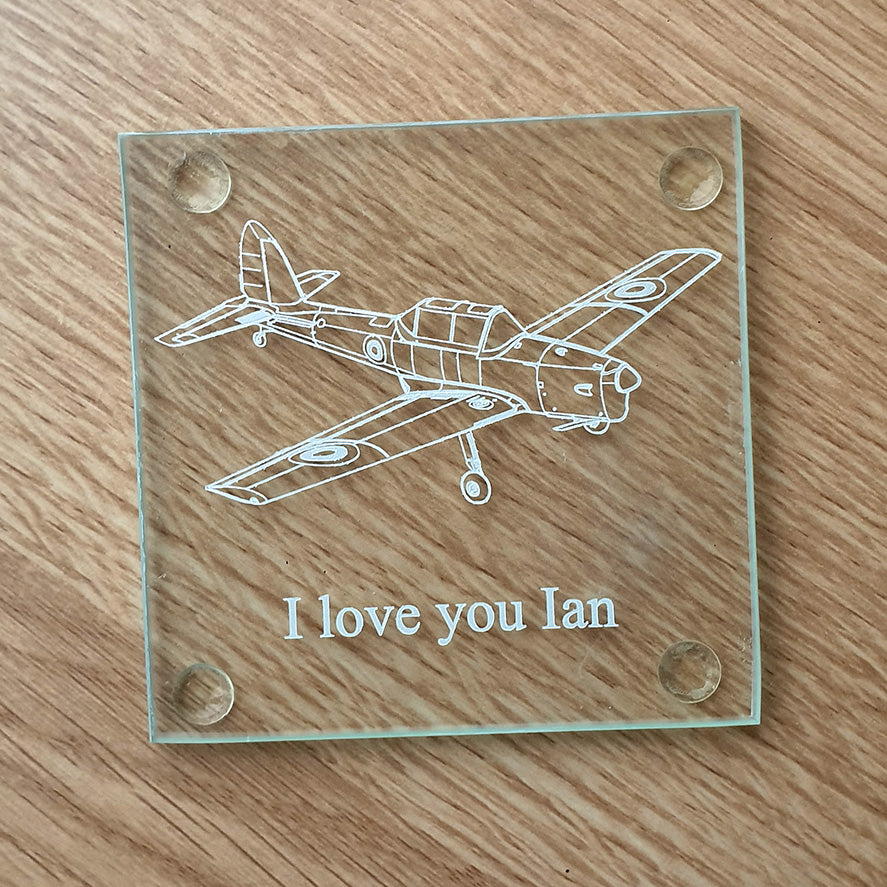 Glass coaster with vintage chipmunk airplane engraving and 'I love you Ian' text on a wooden surface