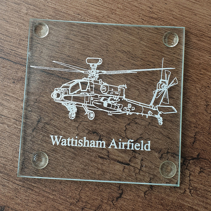 Glass coaster with apache helicopter engraving and 'Wattisham Airfield' text on a wooden surface