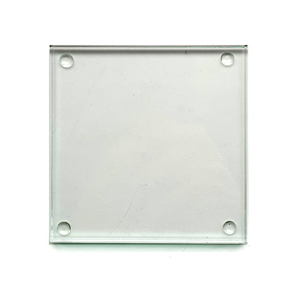 square glass drinks coaster with rubber backing studs shown on a white background