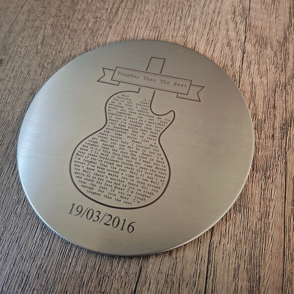 An Engraved round steel Coaster with fine text and a date