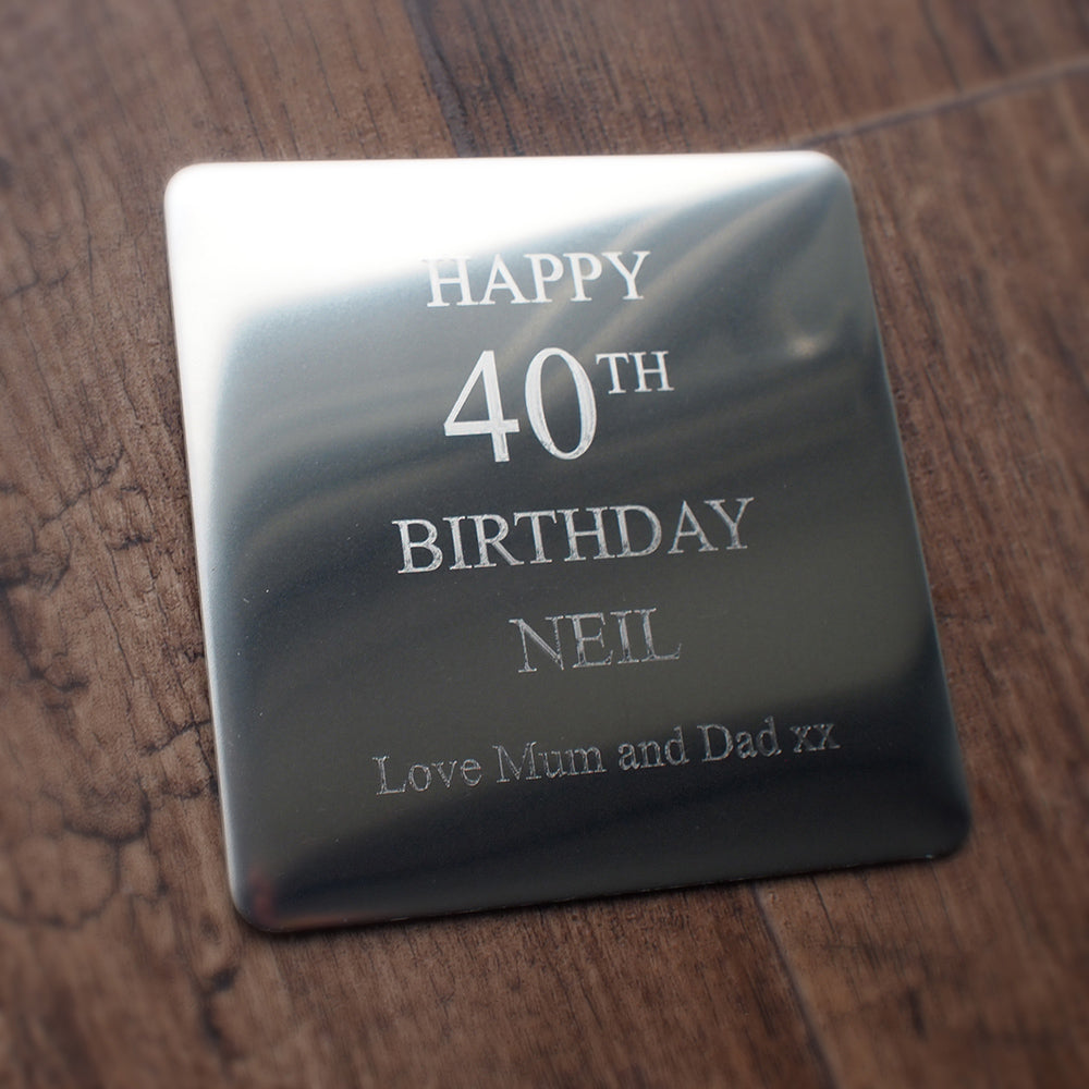 Premium steel drinks coaster with 'Happy 40th Birthday Neil' engraved on a wooden surface background