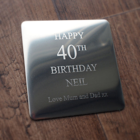 Premium steel drinks coaster with 'Happy 40th Birthday Neil' engraved on a wooden surface background