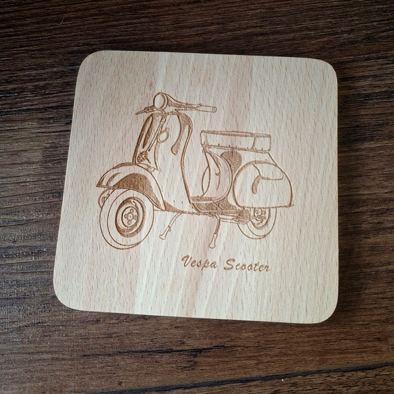 Wooden coaster with Vespa scooter engraving on a wooden surface