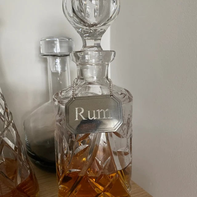 Decanter label oblong engraved with Rum around a whisky decanter