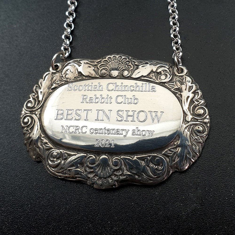 Silver pewter award bottle label on dark background