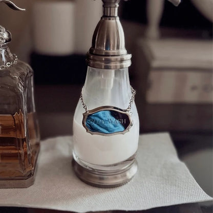 Steel decanter label engraved with body wash over a vintage style bottle