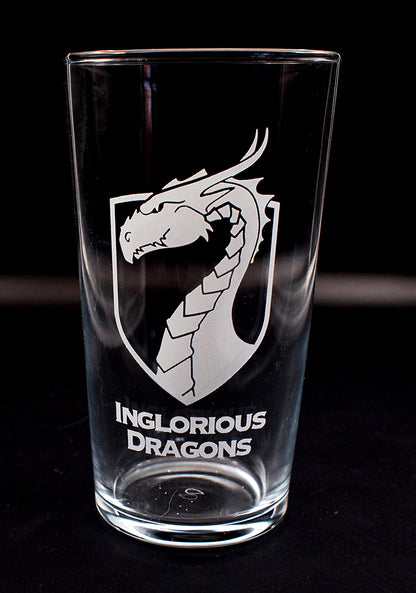 Conical beer glass with 'Inglorious Dragons' logo on a black background