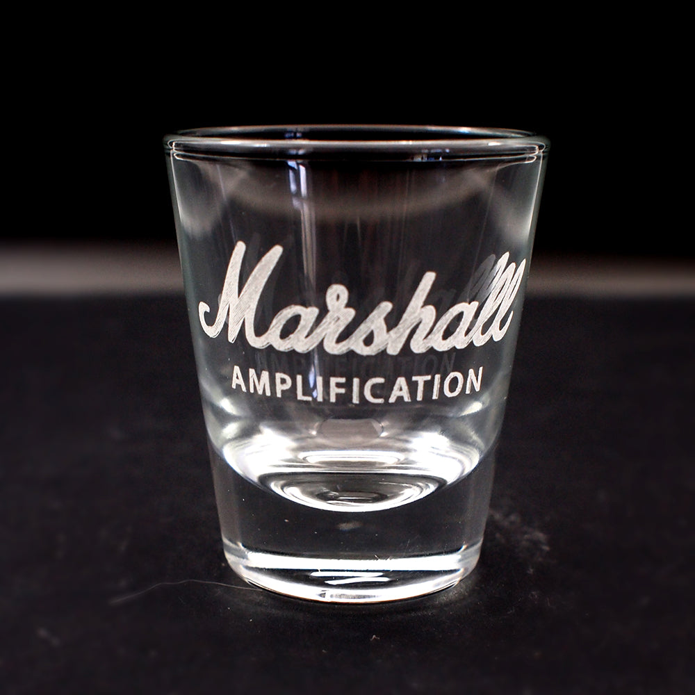 Clear glass with 'Marshall Amplification' engraving on a black background