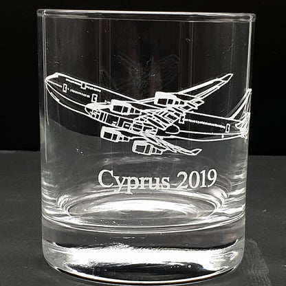 Clear glass tumbler with a Boeing 747 airplane engraving and 'Cyprus 2019' text on a black background
