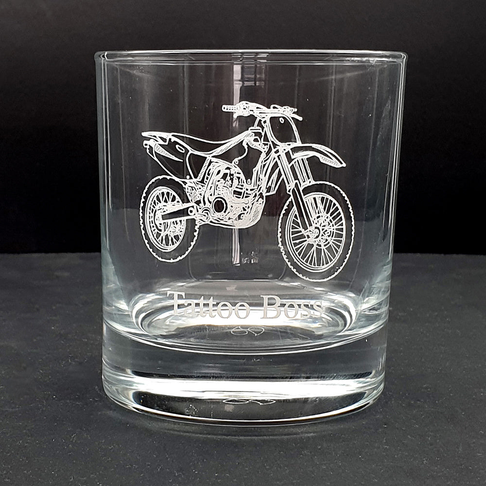 Clear glass tumbler with a Motocross motorcycle engraving and 'Tattoo Boys' text on a black background