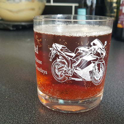 Close up of a Racing bike artwork engraved on the side of a full tumbler in a kitchen environment.