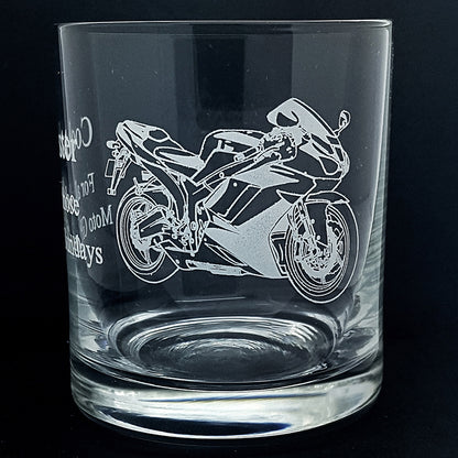 Clear glass tumbler with a motorcycle engraving on a black background