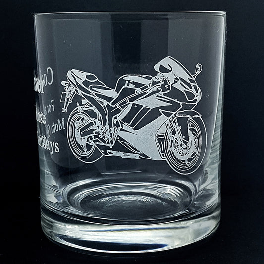 Clear glass tumbler with a motorcycle engraving on a black background