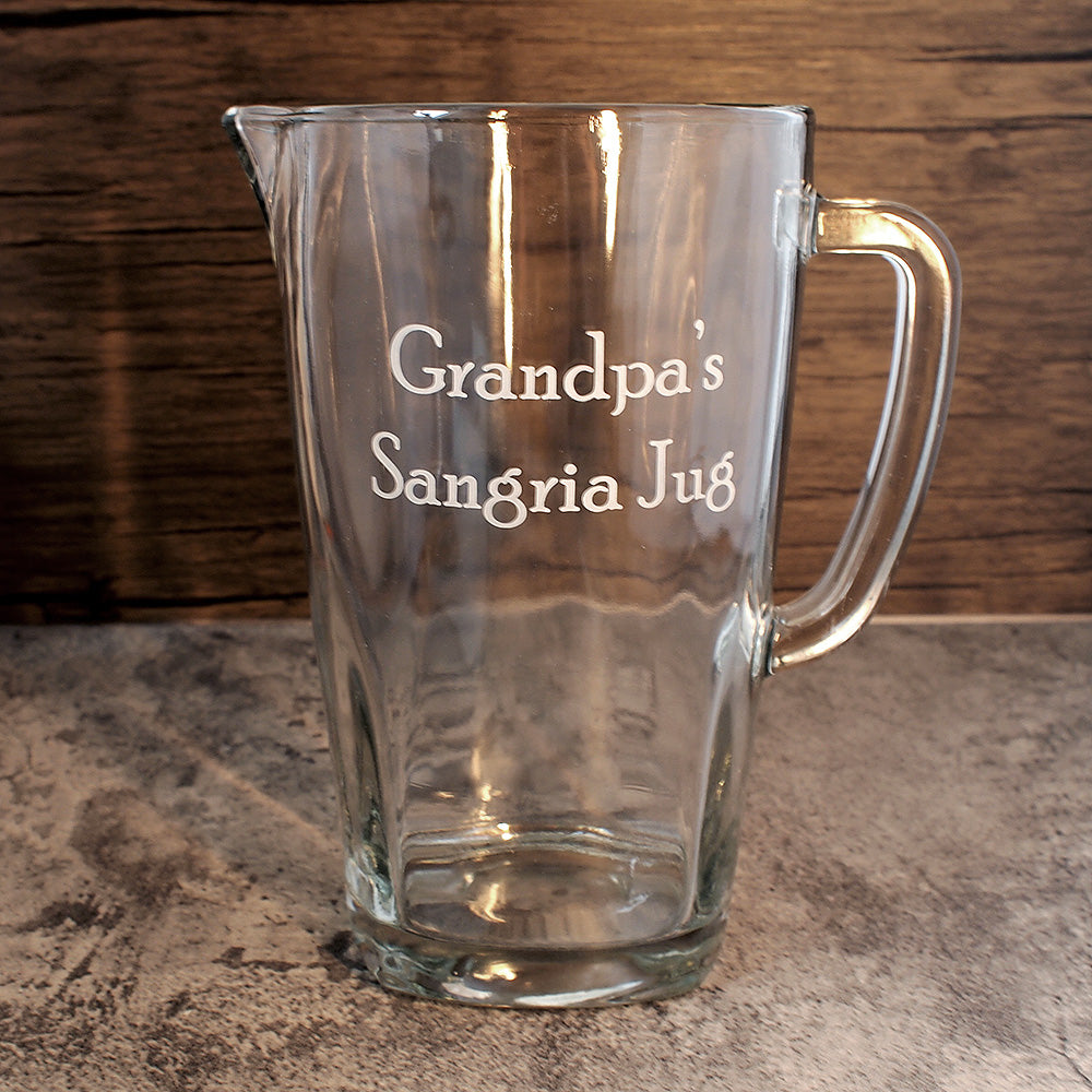 A glass pitcher jug engraved with Grandpa's Sangria Jug