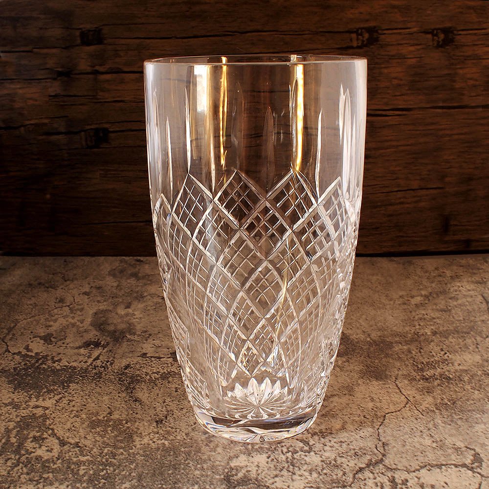 full front image of large glass solitaire vase with intricate hand cut detailing