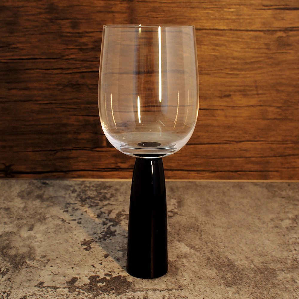 anton studios raised wine glass with long black stem