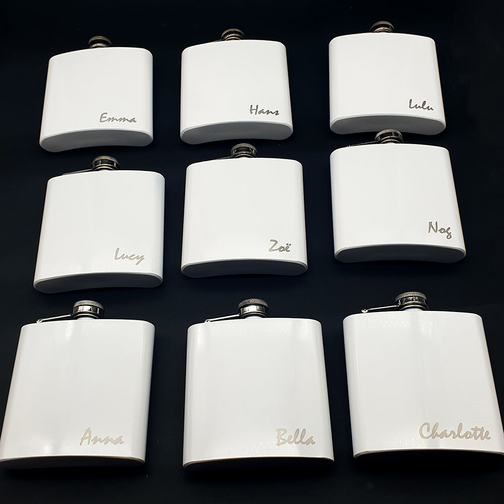 Set of white flasks  with names engraved in lower right of each.