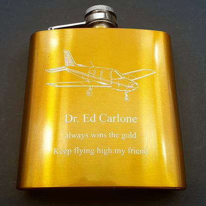 Gold Hip Flask with Piper PA28 aircraft engraved and personalised messaged engraved below.