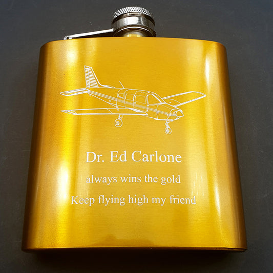 Gold Hip Flask with Piper PA28 aircraft engraved and personalised messaged engraved below.