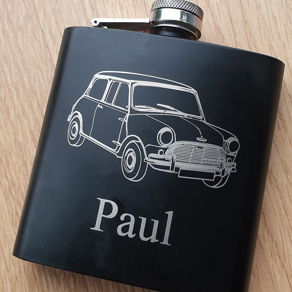 Black flask with a classic mini car illustration and 'Paul' text on a wooden surface