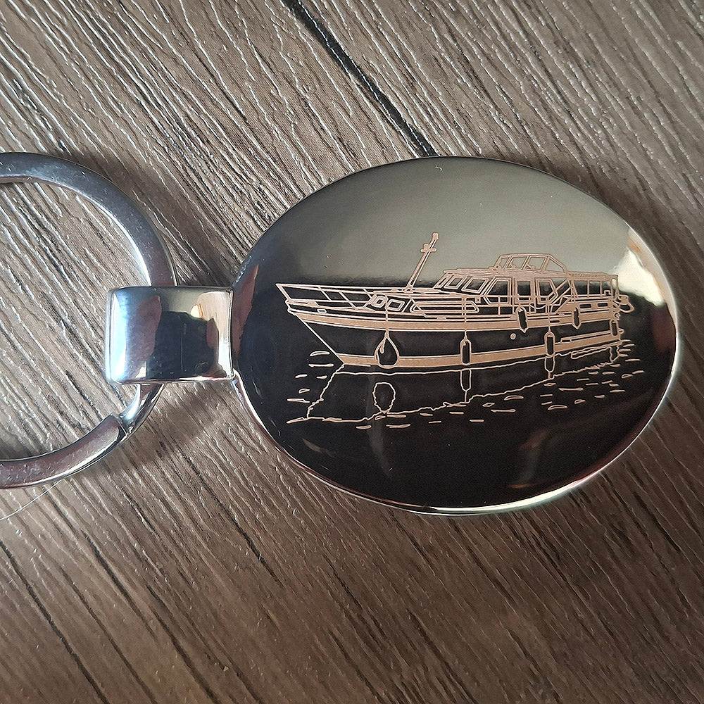 Chrome plated oval keyring engraved with our Stevens 1140 Canal Yacht Artwork