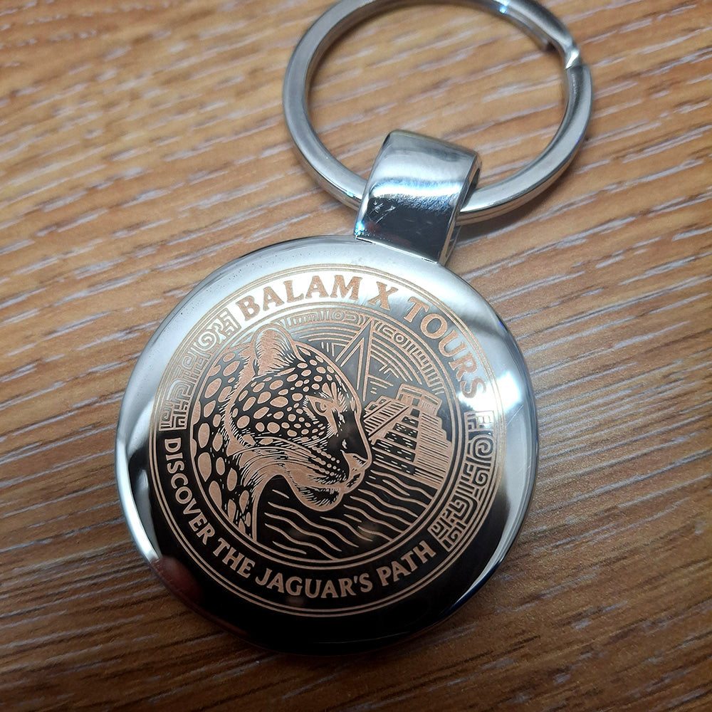 Round Silver keyring with a high detail Jaguar and Pyramid logo engraved on the front