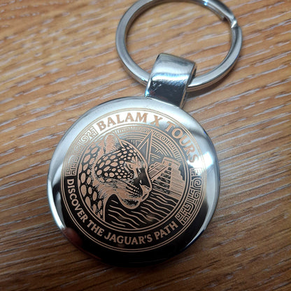 Round Silver keyring with a high detail Jaguar and Pyramid logo engraved on the front