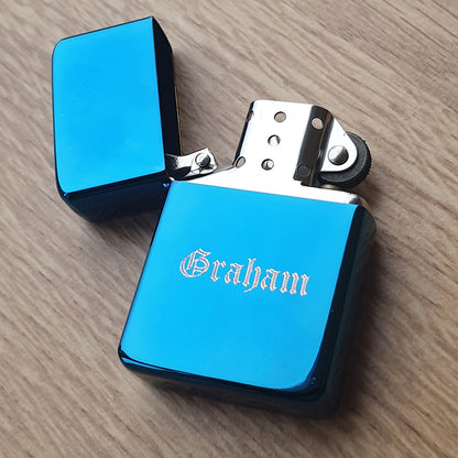 Blue lighter with 'Graham' engraving on a wooden surfacein Old English font