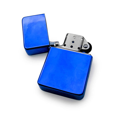 Blue petrol lighter with open lid on a white background