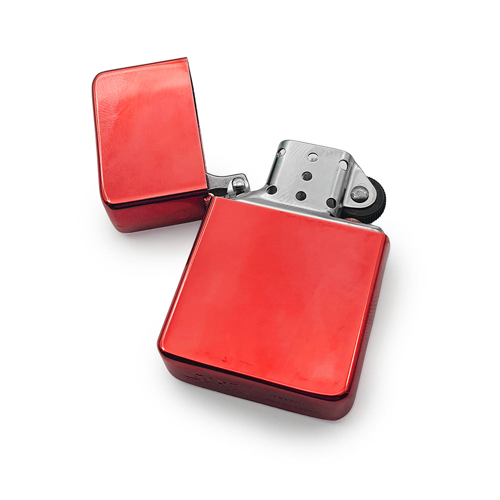 Red petrol lighter with open lid on a white background