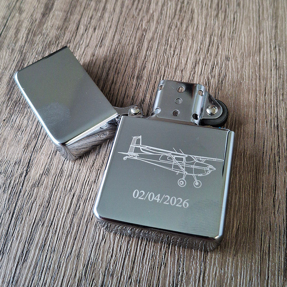 Silver chrome lighter engraved with our Cessna 180 artwork and a date.